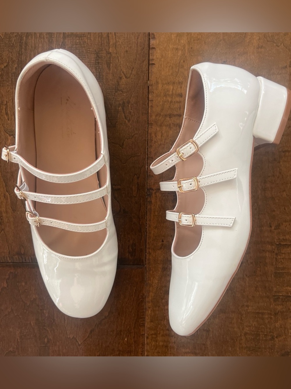 White patent leather triple-strap Mary Janes with low, sturdy block heels